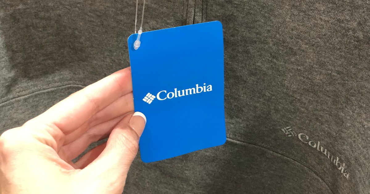 woman holding columbia tag