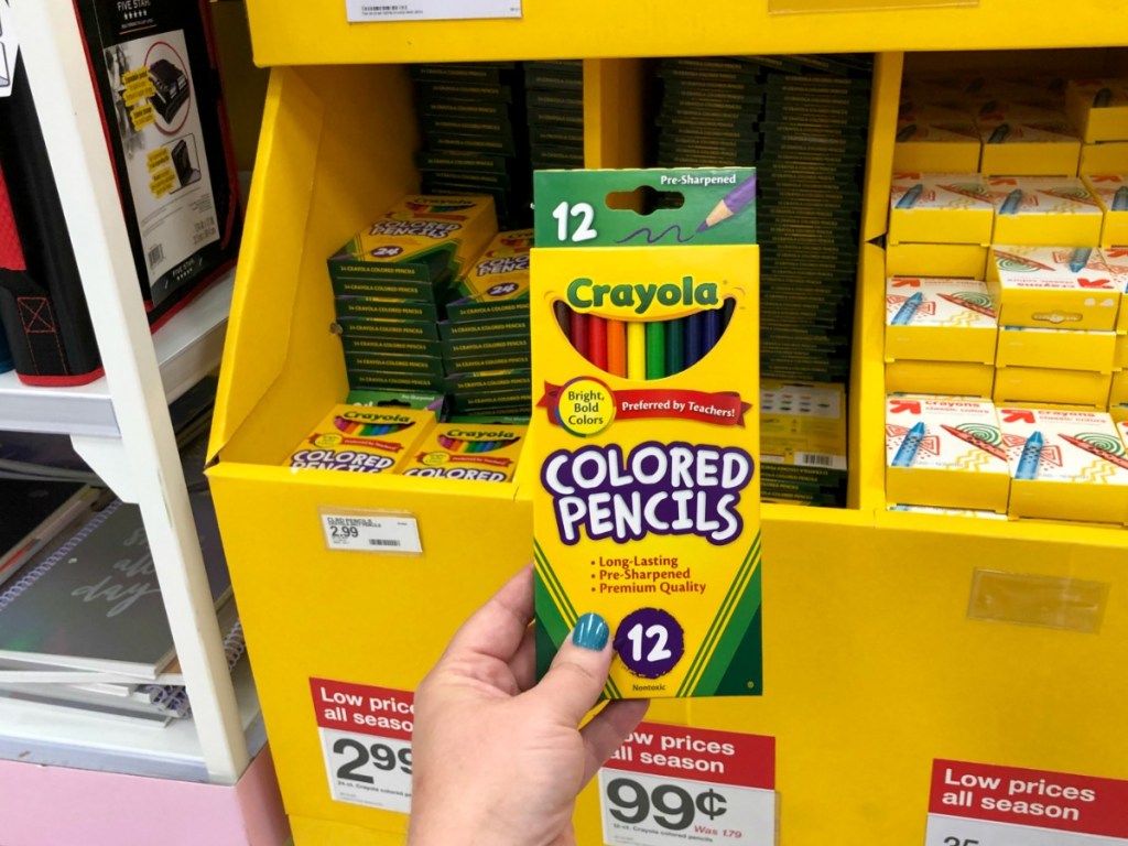 hand holdling crayola pencils