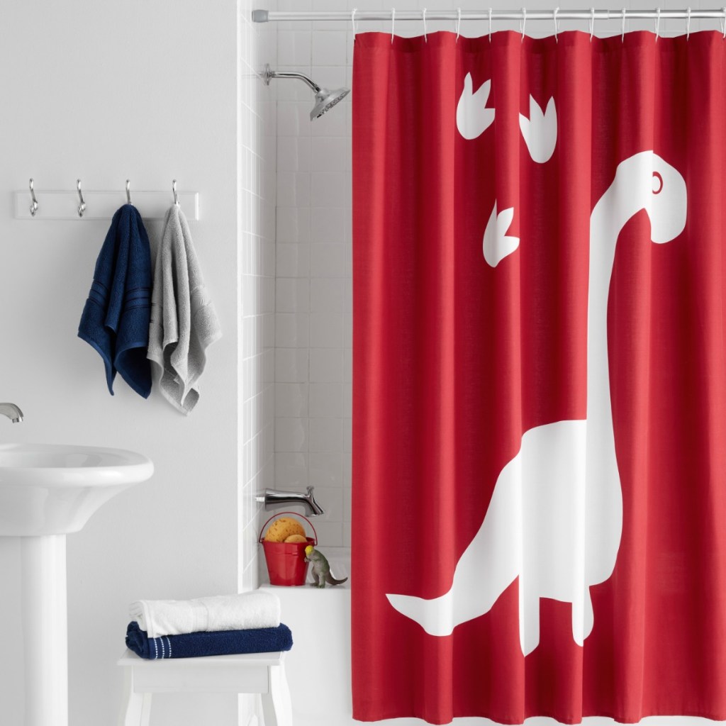 Dinosaur themed shower curtain in red from Walmart in white bathroom