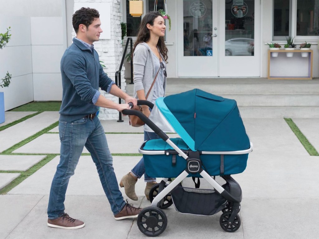 Man and woman walking with Diono Quantum Stroller