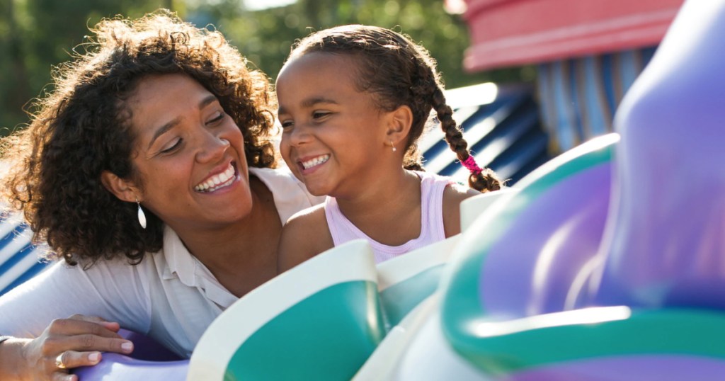 Mom and daughter littel girl riding Dumbo ride at Disney World