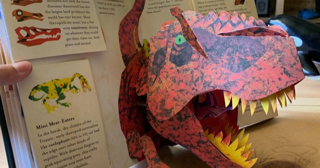 T-rex popping up out of a dinosaur pop-up book