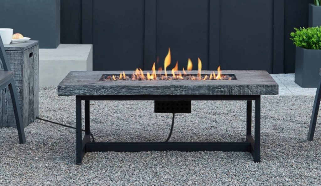 Fire table on outdoor patio with fire blazing