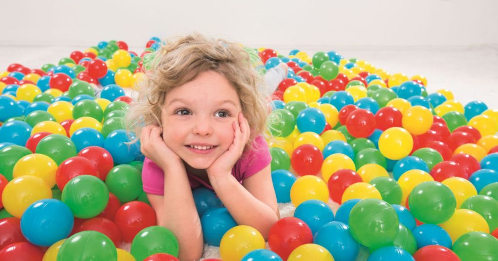 Little Girl laying in Fisher-Price Play Balls
