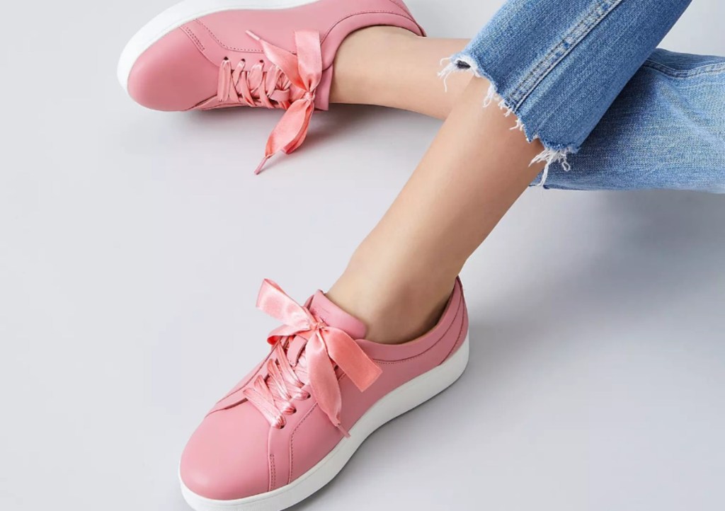 woman wearing pink sneakers