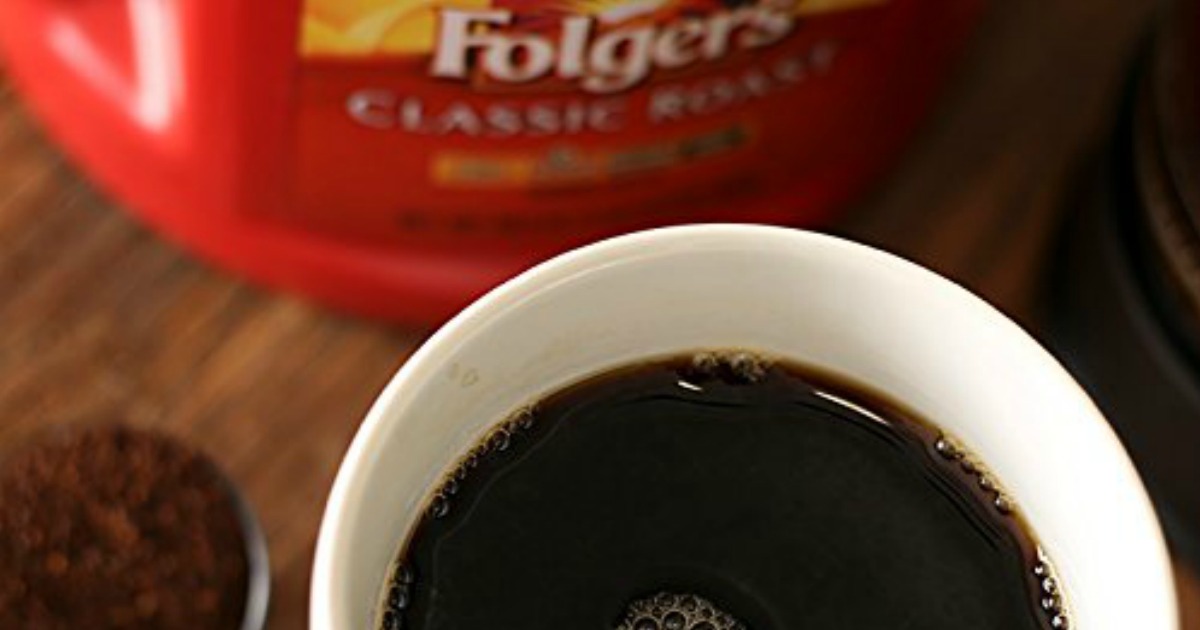 Folgers brand classic roast coffee canister near mug with brewed coffee