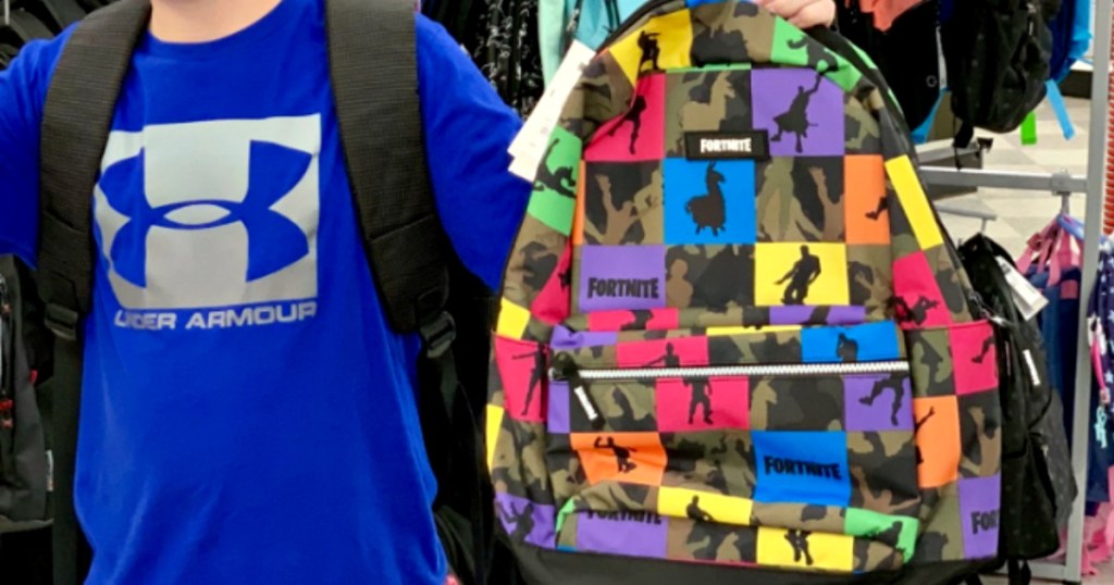 boy holding fortnite backpack at store