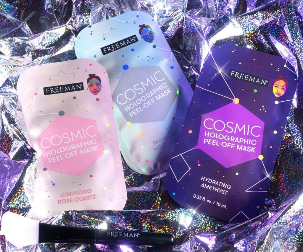 Freeman Beauty cosmic facial masks on shiny background in three varieties with brush 