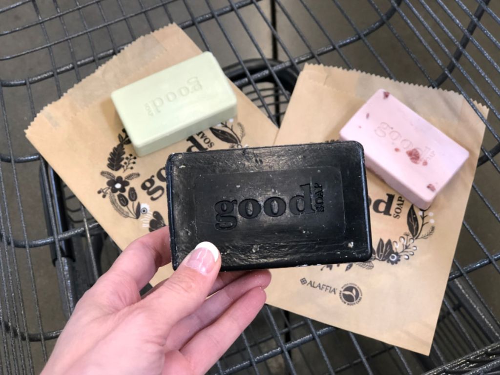 woman hand holding black Good Soap at Whole Foods