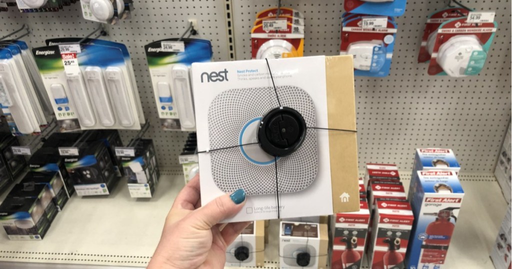 woman holding google nest protect