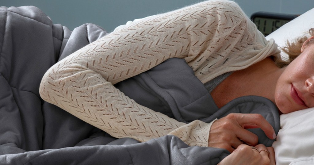 Woman laying in bed with Gray Weighted Blanket from Zulily
