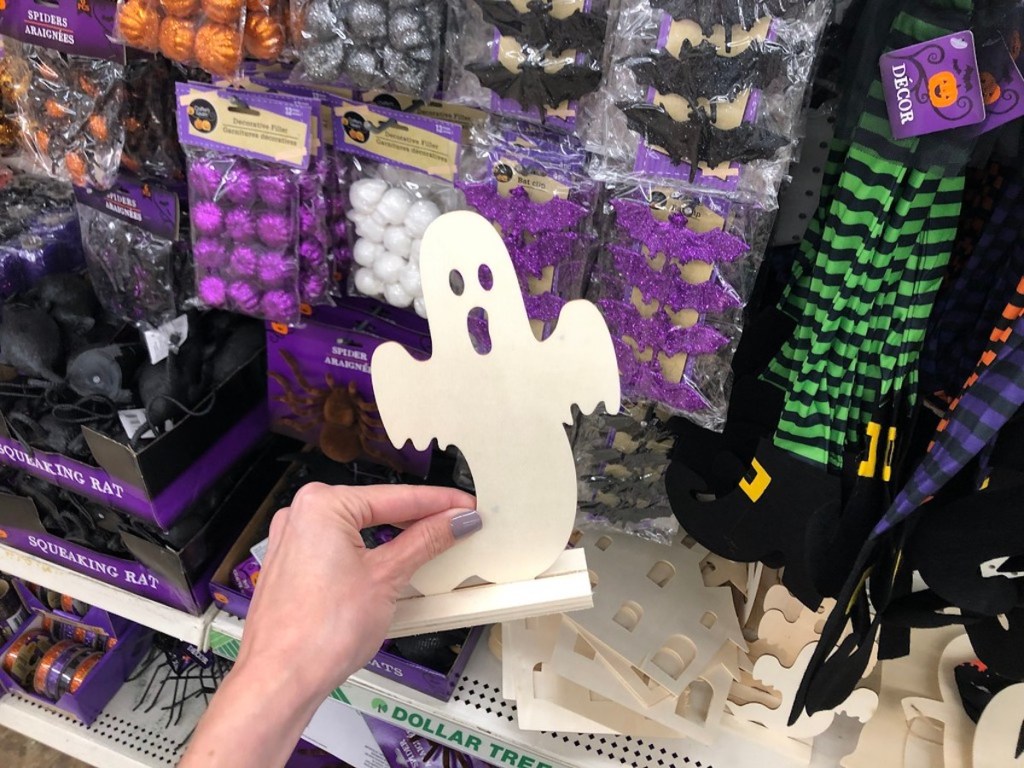 hand holding wooden ghost