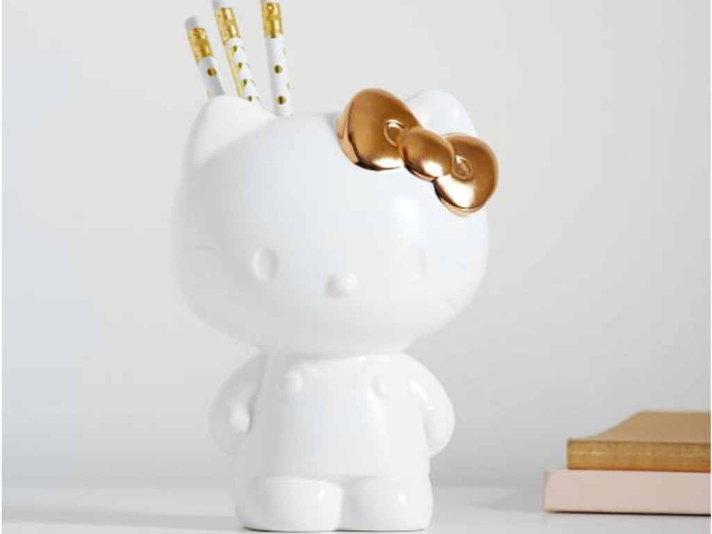 white hello kitty pencil holder with gold bow