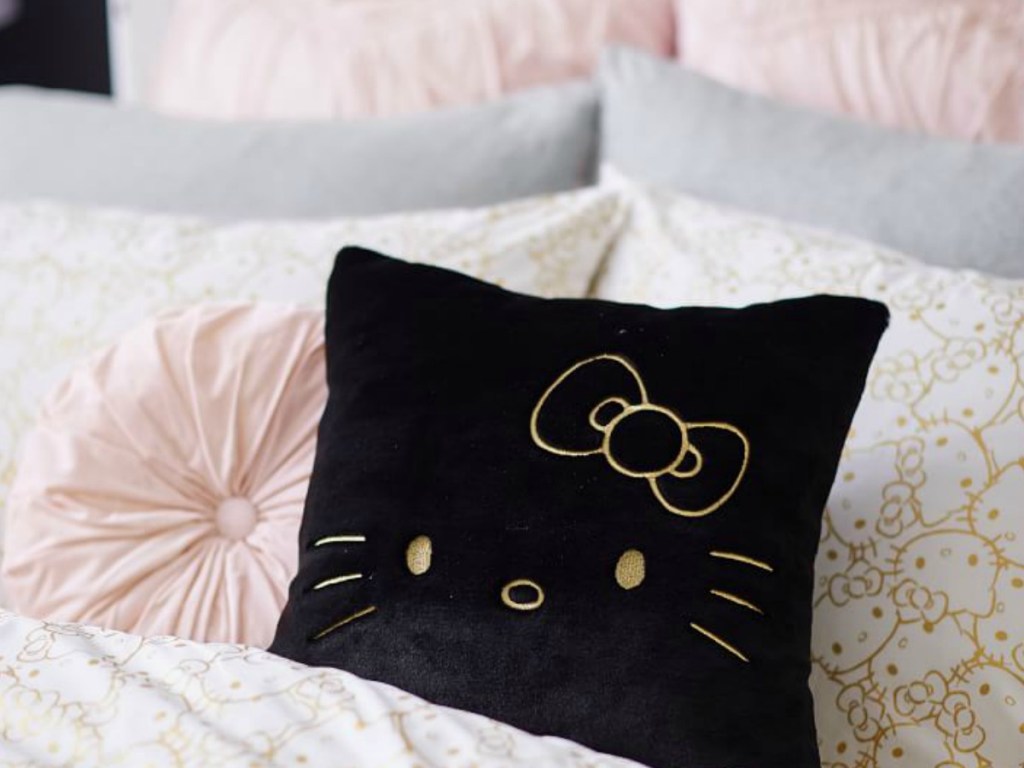 black hello kitty pillow on bed