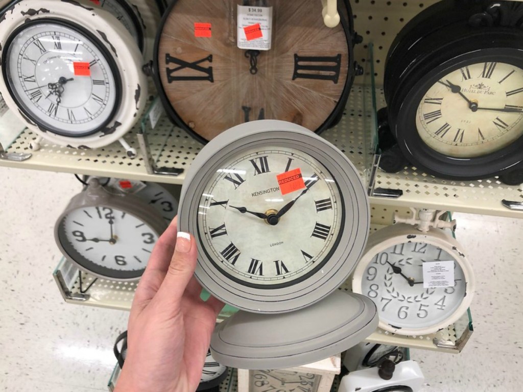 lady holding a table clock on clearance at Hobby Lobby
