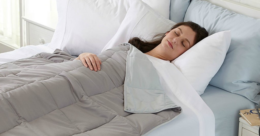 woman sleeping on bed with blanket