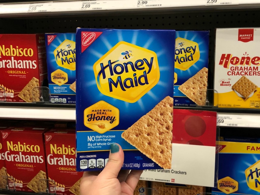 Hand holding up Honey Maid Graham Crackers in Target