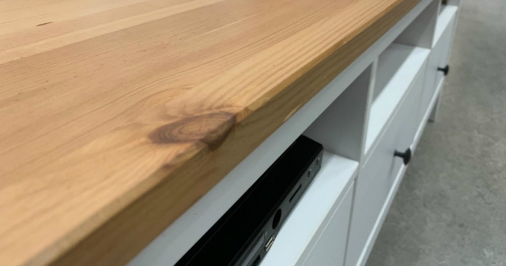 close up of IKEA TV stand with wood top