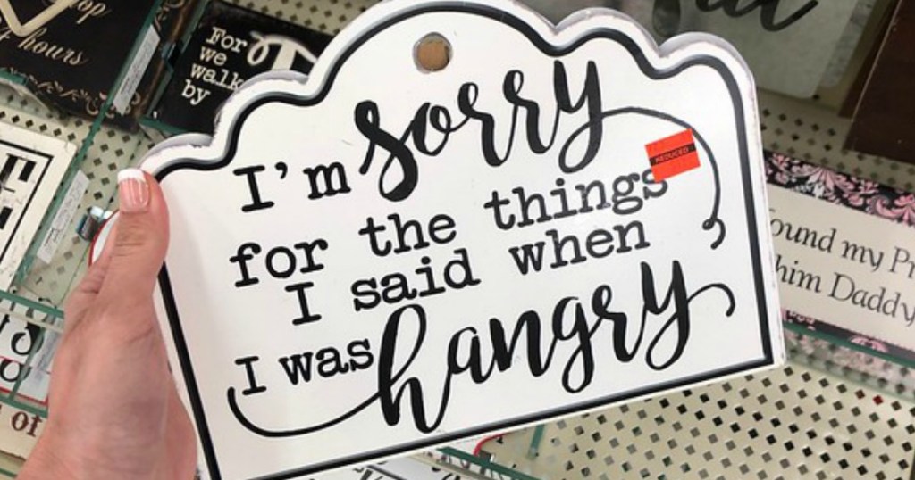 lady holding an 'Im Sorry for the things I said when I was Hangry sign' at Hobby Lobby