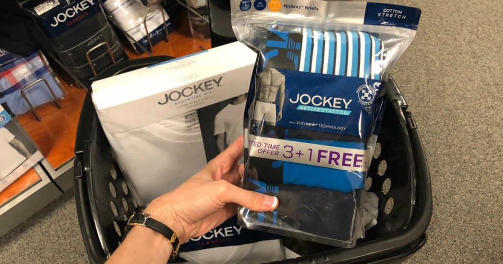 woman holding package of Jockey men's boxers over Kohl's shopping cart