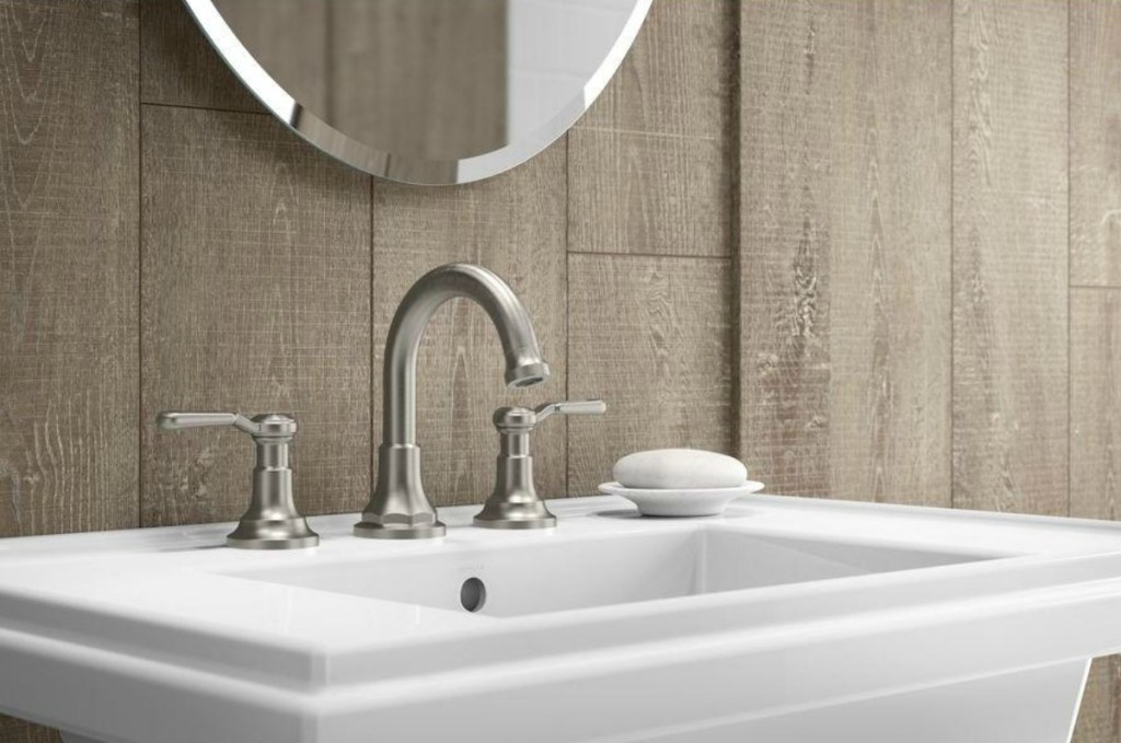 KOHLER brand bathroom faucet on ivory sink with soap