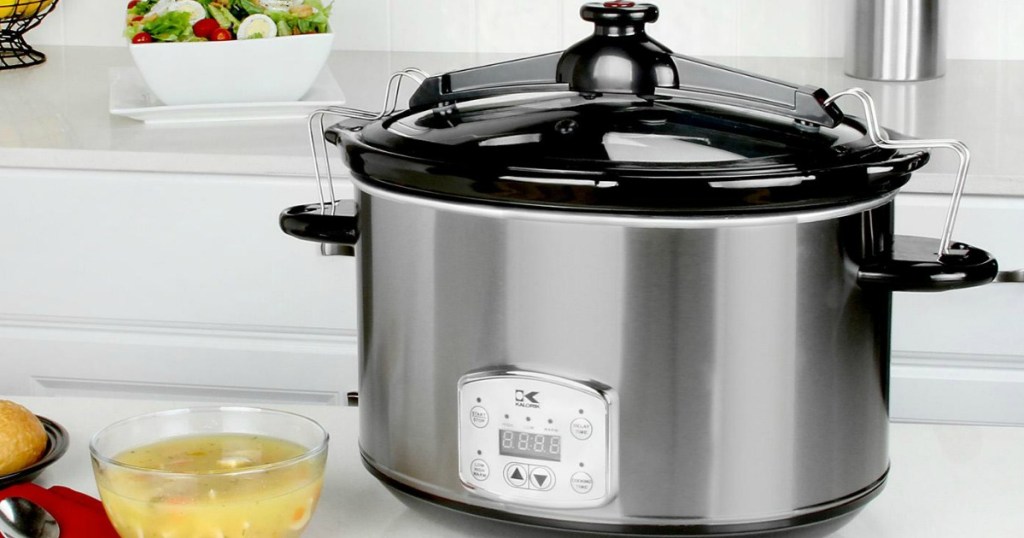 silver slow cooker sitting on a counter