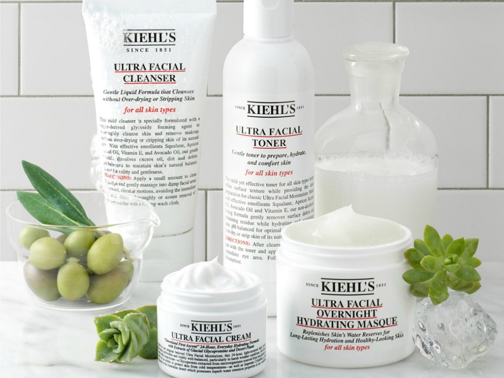 Kiehl's ultra facial cleanser, ultra facial toner, ultra facial cream, ultra facial overnight hydrating masque in bathroom with white tile and grapes