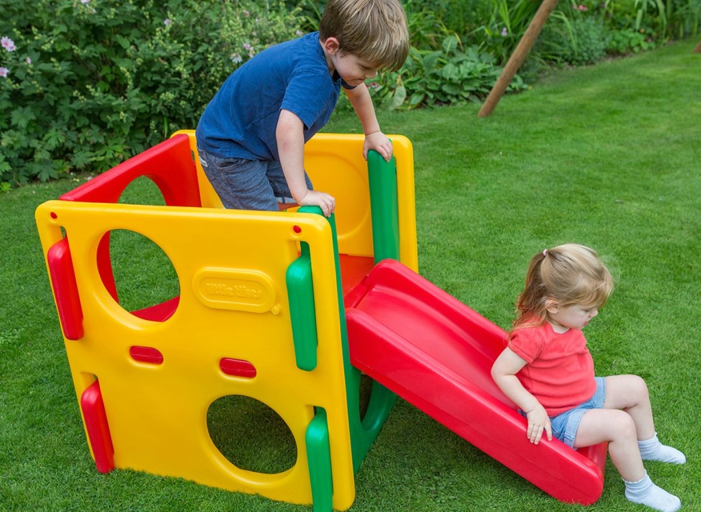 boy and girl playing on Little Tikes Jr. Activity Jungle Gym outside