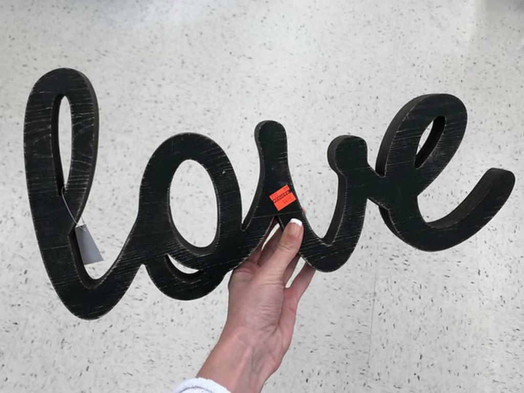 lady holding a 'love' sign at Hobby Lobby
