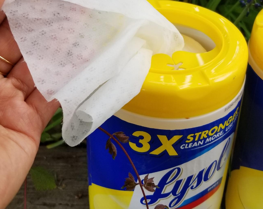 hand pulling out Lysol Wipes