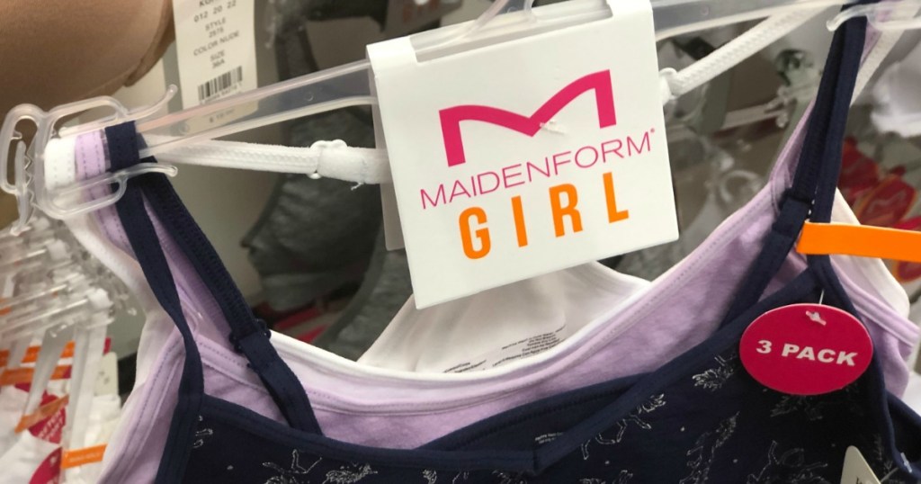 Close up of Three pack of Maidenform brand girls bras on hanger in-hand at store