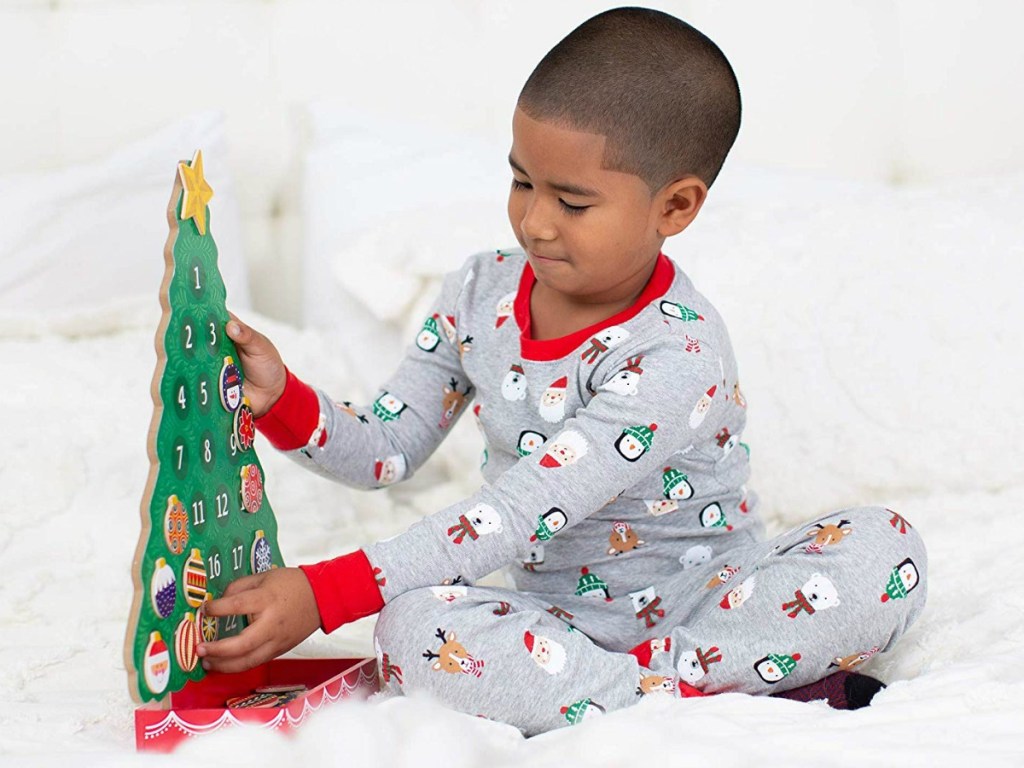 boy playing with wooden advent tree