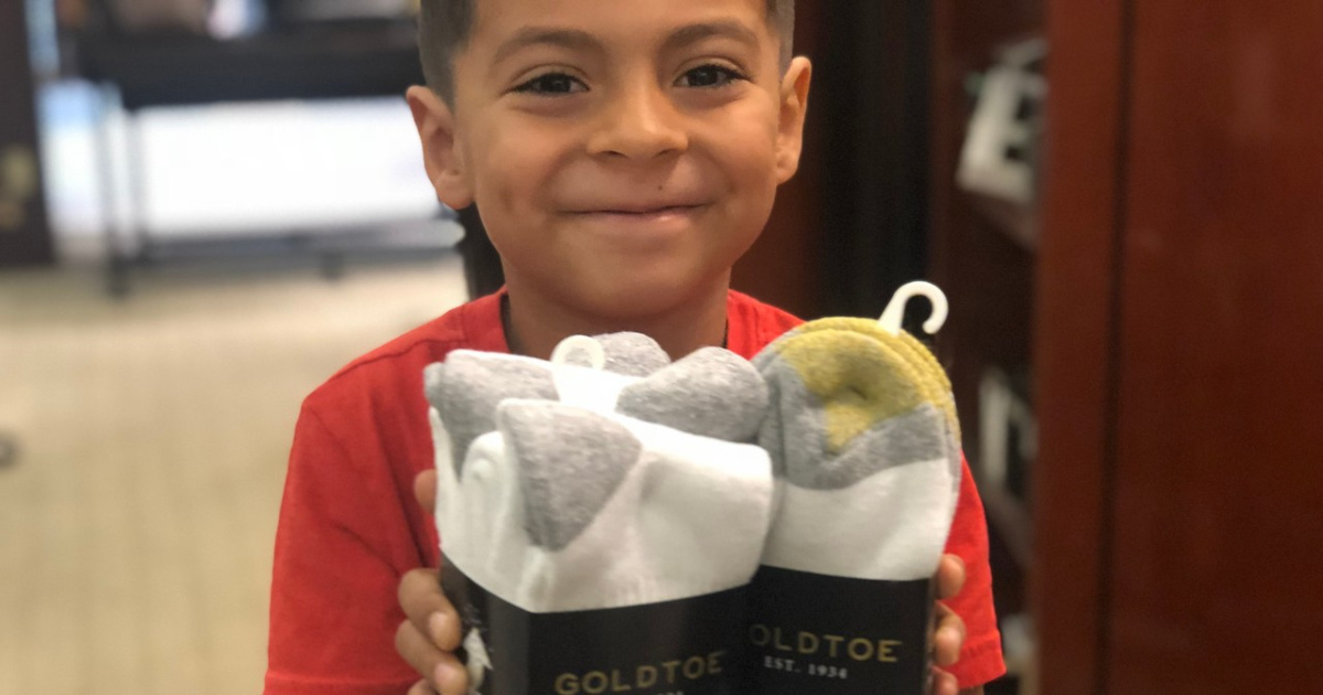 boy holding pack of mens gold toe socks