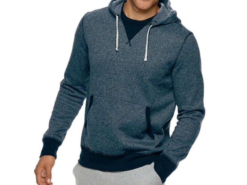 man wearing hoodie with hand in pocket