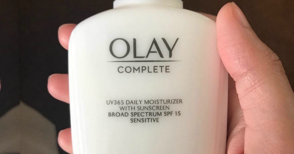 Olay Complete Lotion bottle held in hand