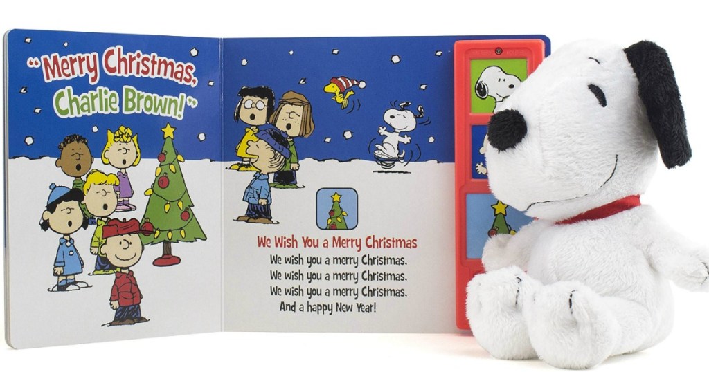 snoppy plush toy next to a Peanuts book