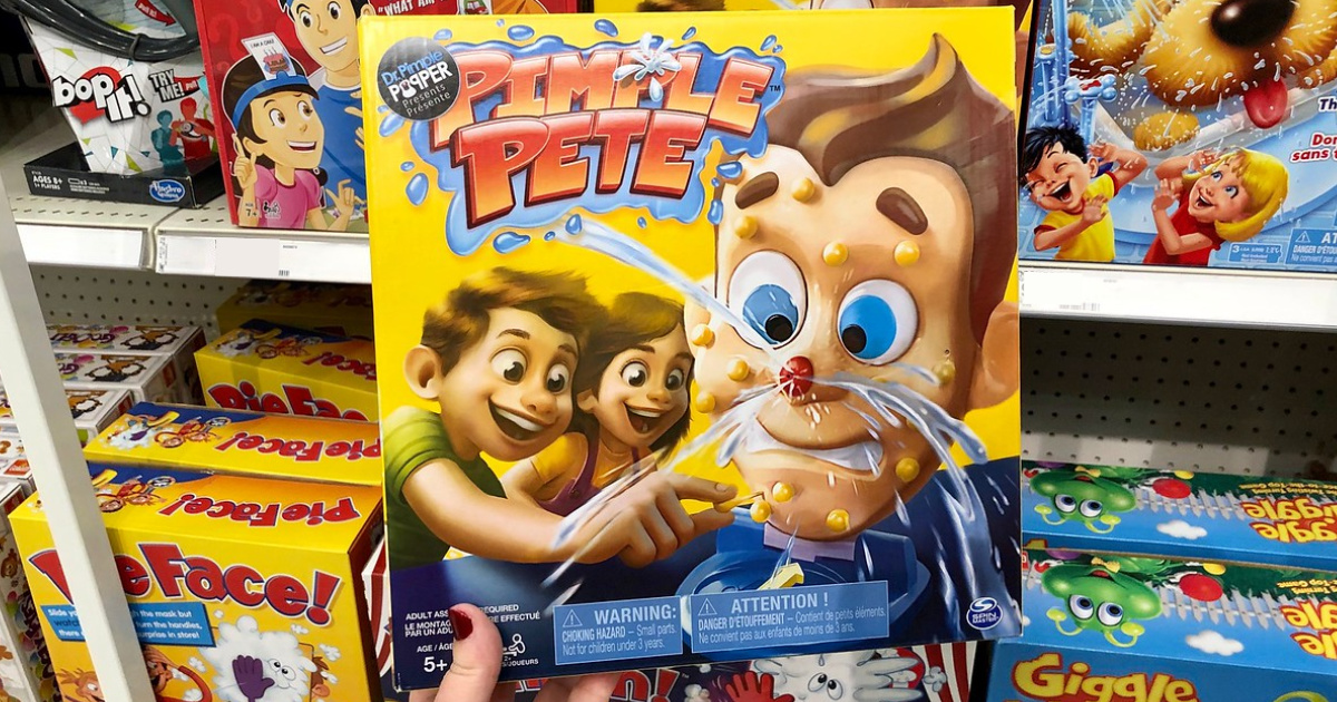 pimple pete board game being held in front of a store shelf