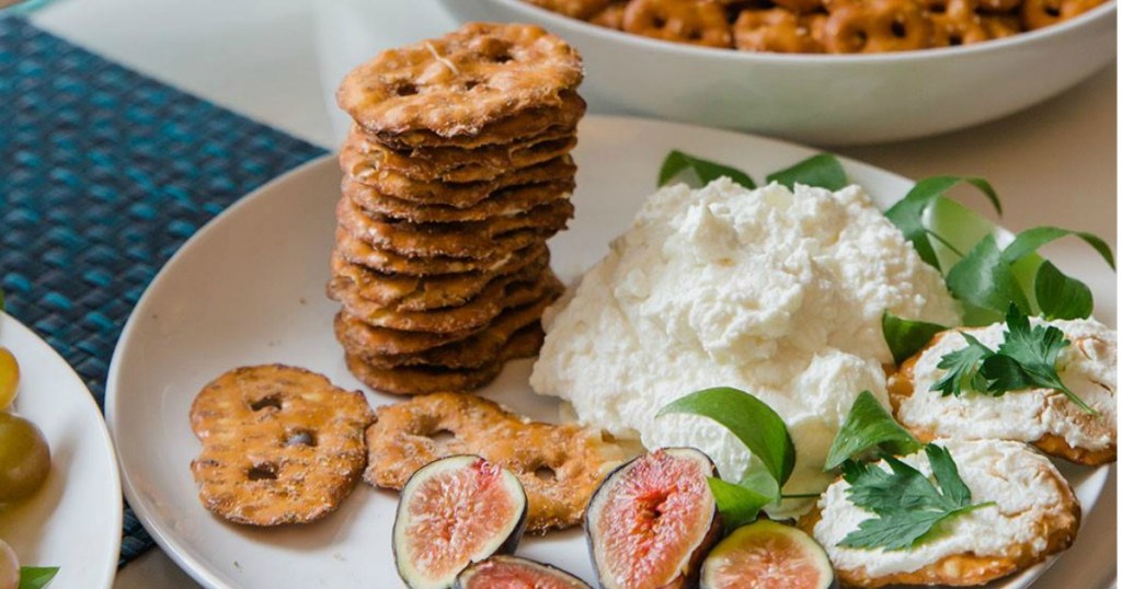 Pretzel crisps on tray with dip and fresh figs