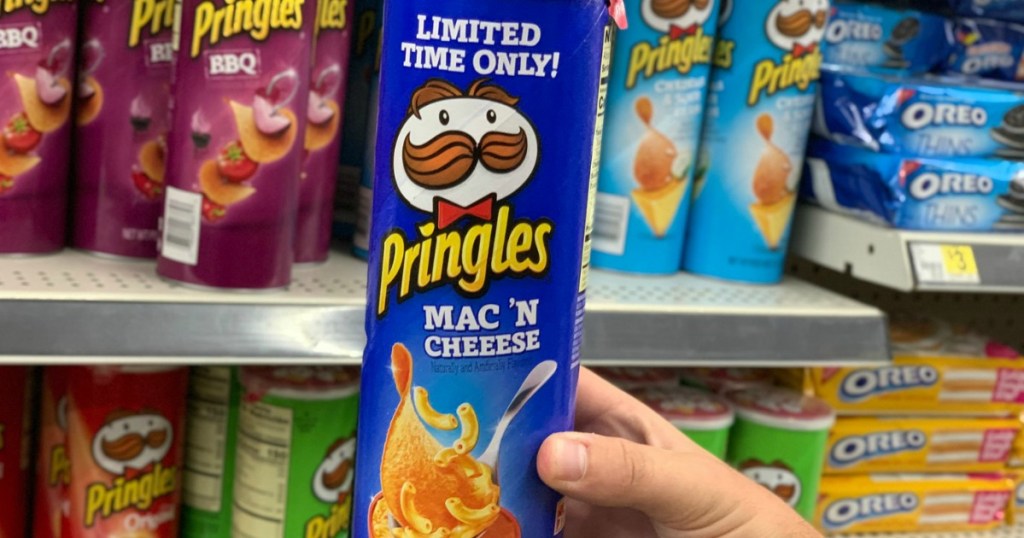 Hand holding Pringles Mac & Cheese in Dollar General Aisle