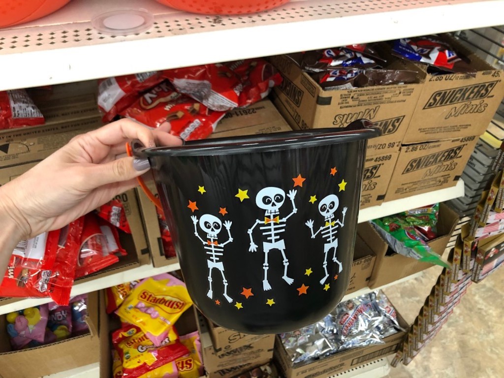 hand holding Halloween bucket
