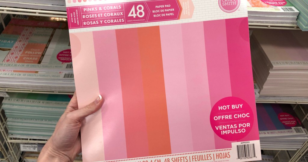 woman holding pink scrapbooking paper