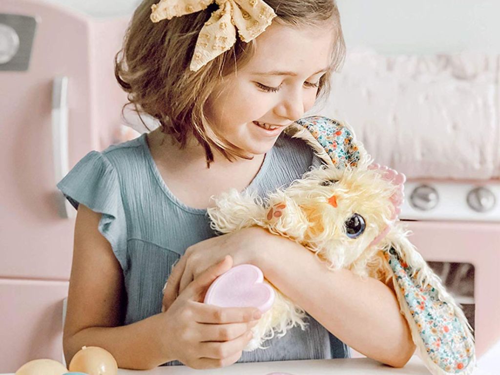 girl holding Scruff-a-luvs Blossom Bunny in yellow