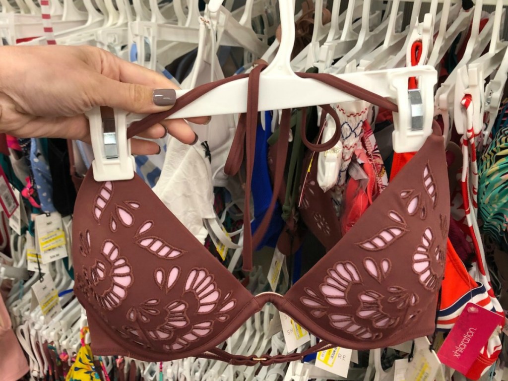 hand holding hanger with bikini top in store