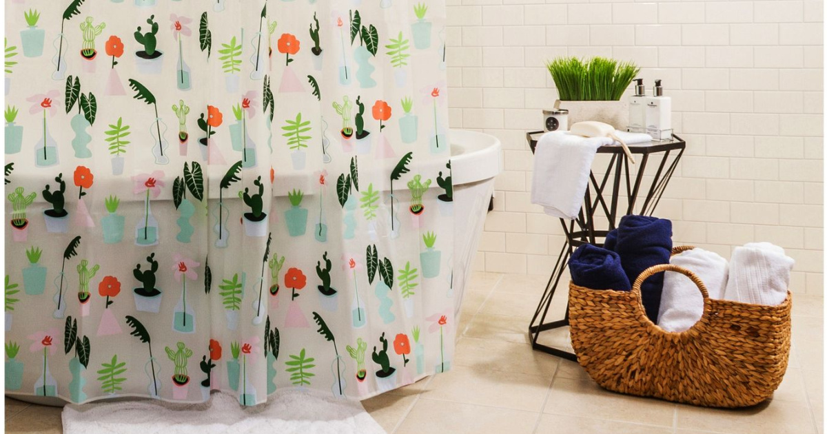 printed shower curtain in bathroom next to table and basket