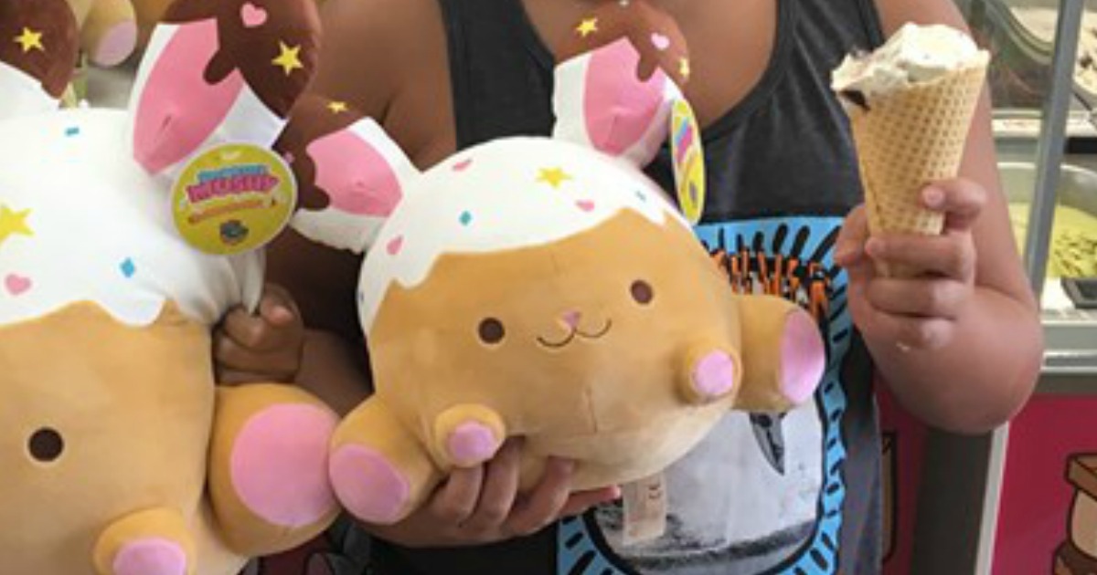 boy holding a smoosy mushy bunny toy and ice cream cone