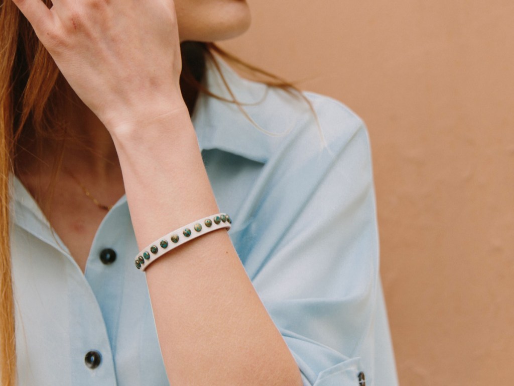 Woman wearing Starfish Project Hazel White; Leather & Brass Bracelet