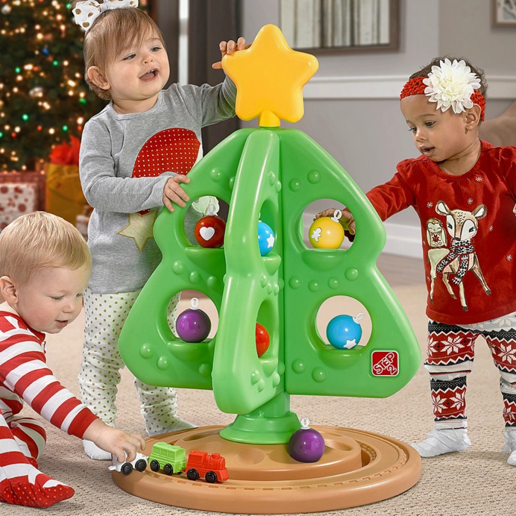 Kids playing with a Step2 Christmas tree