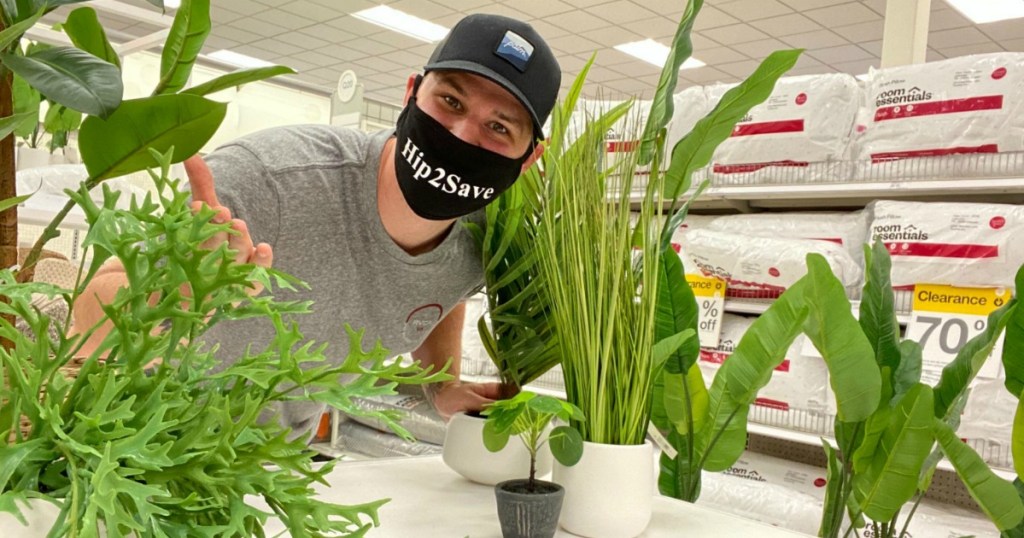 man surrounded by fake plants at Target 