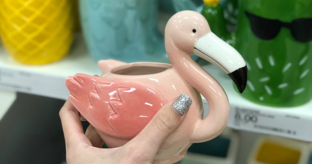 Hand holding flamingo planter
