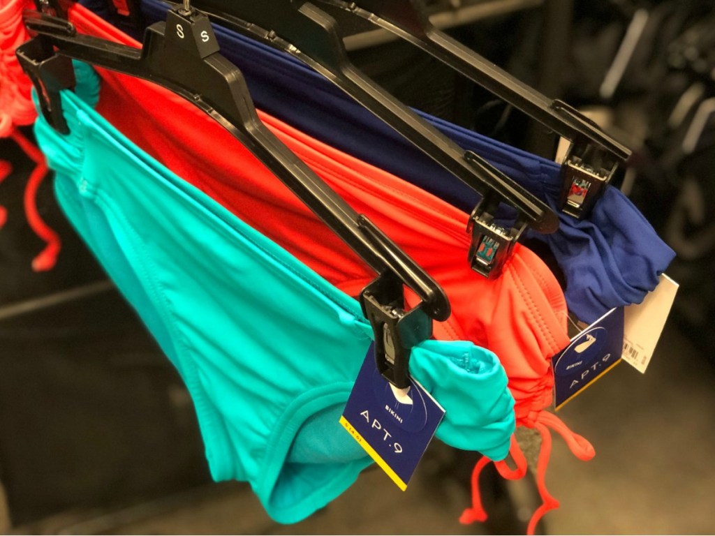 Brightly colored bikini bottoms on hangers
